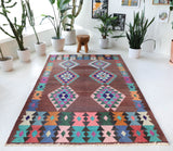 Vintage kilim rug in living room setting, old rug, antique rug, pastel colors, faded colors, Turkish rug, vintage rug, soft rug, Portland, Oregon, rug store, rug shop, local shop, earthy tones, earthy colors, warm colors