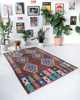 Vintage kilim rug in living room setting, old rug, antique rug, pastel colors, faded colors, Turkish rug, vintage rug, soft rug, Portland, Oregon, rug store, rug shop, local shop, earthy tones, earthy colors, warm colors