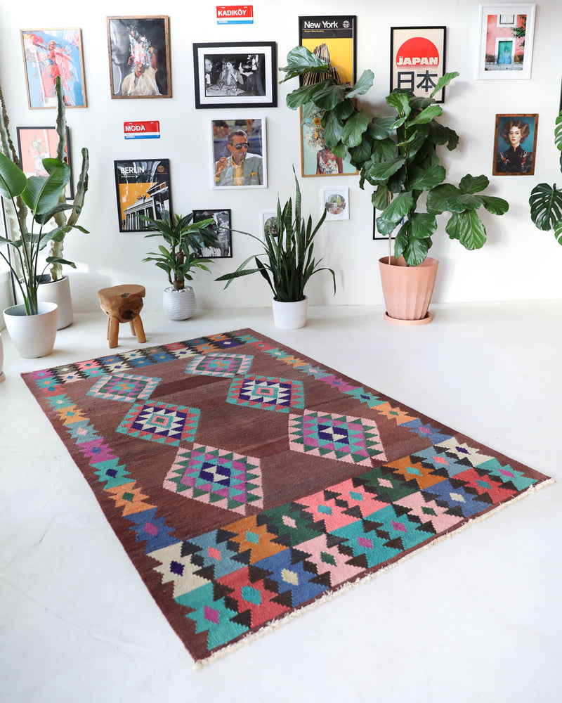 Vintage kilim rug in living room setting, old rug, antique rug, pastel colors, faded colors, Turkish rug, vintage rug, soft rug, Portland, Oregon, rug store, rug shop, local shop, earthy tones, earthy colors, warm colors