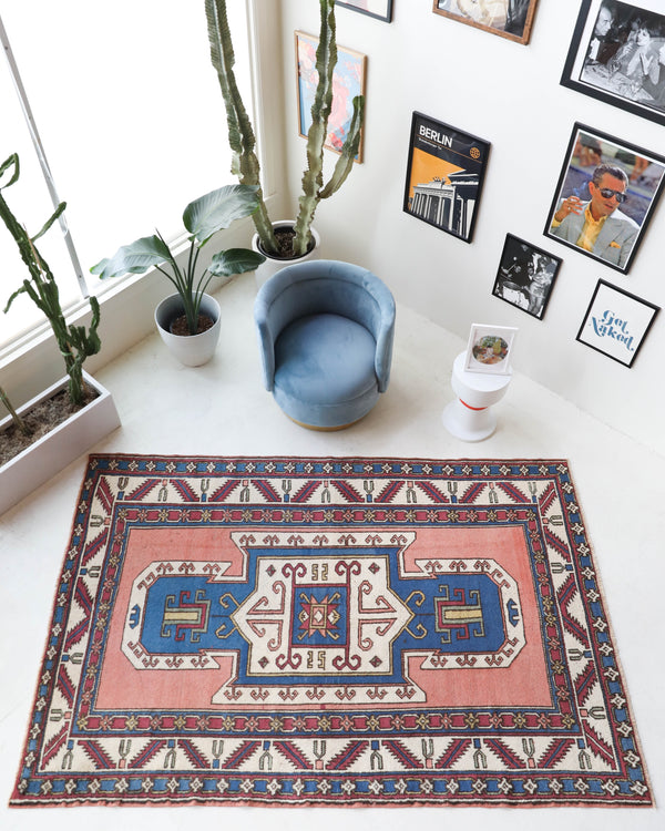 Vintage Turkish rug in a living room setting, Area rug in a living room setting, pile rug, Turkish rug, old rug, antique rug, pastel colors, faded colors, Turkish rug, vintage rug, soft rug, Portland, Oregon, rug store, rug shop, local shop, distressed rug, worn out rug