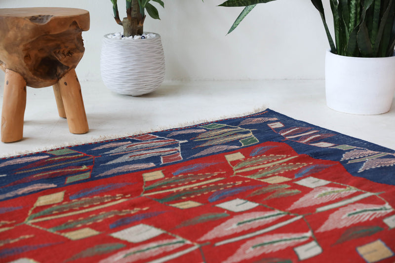 Vintage kilim rug in living room setting, old rug, antique rug, pastel colors, faded colors, Turkish rug, vintage rug, soft rug, Portland, Oregon, rug store, rug shop, local shop, earthy tones, earthy colors, warm colors