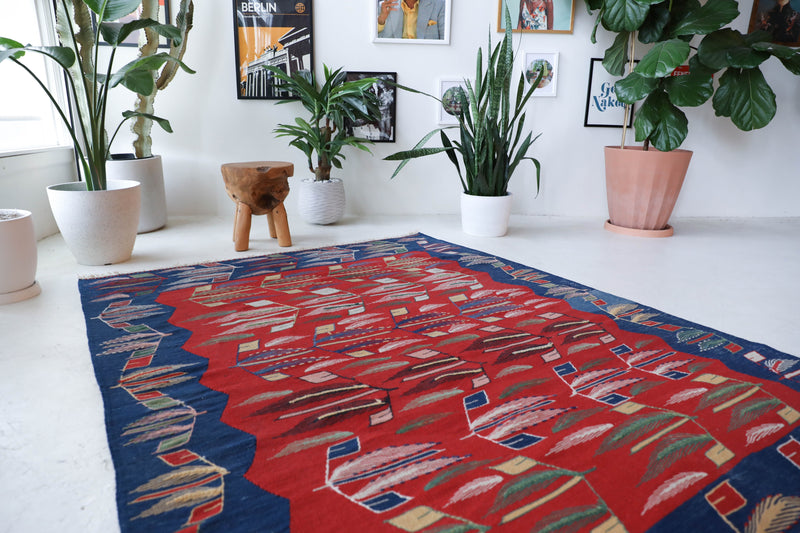 Vintage kilim rug in living room setting, old rug, antique rug, pastel colors, faded colors, Turkish rug, vintage rug, soft rug, Portland, Oregon, rug store, rug shop, local shop, earthy tones, earthy colors, warm colors