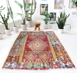 Vintage kilim rug in room decor setting, old rug, antique rug, pastel colors, faded colors, Turkish rug, vintage rug, soft rug, Portland, Oregon, rug store, rug shop, local shop, bold colors, bright colors, faded colors