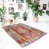 Vintage kilim rug in room decor setting, old rug, antique rug, pastel colors, faded colors, Turkish rug, vintage rug, soft rug, Portland, Oregon, rug store, rug shop, local shop, bold colors, bright colors, faded colors