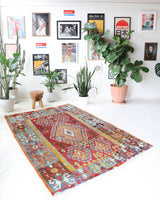 Vintage kilim rug in room decor setting, old rug, antique rug, pastel colors, faded colors, Turkish rug, vintage rug, soft rug, Portland, Oregon, rug store, rug shop, local shop, bold colors, bright colors, faded colors