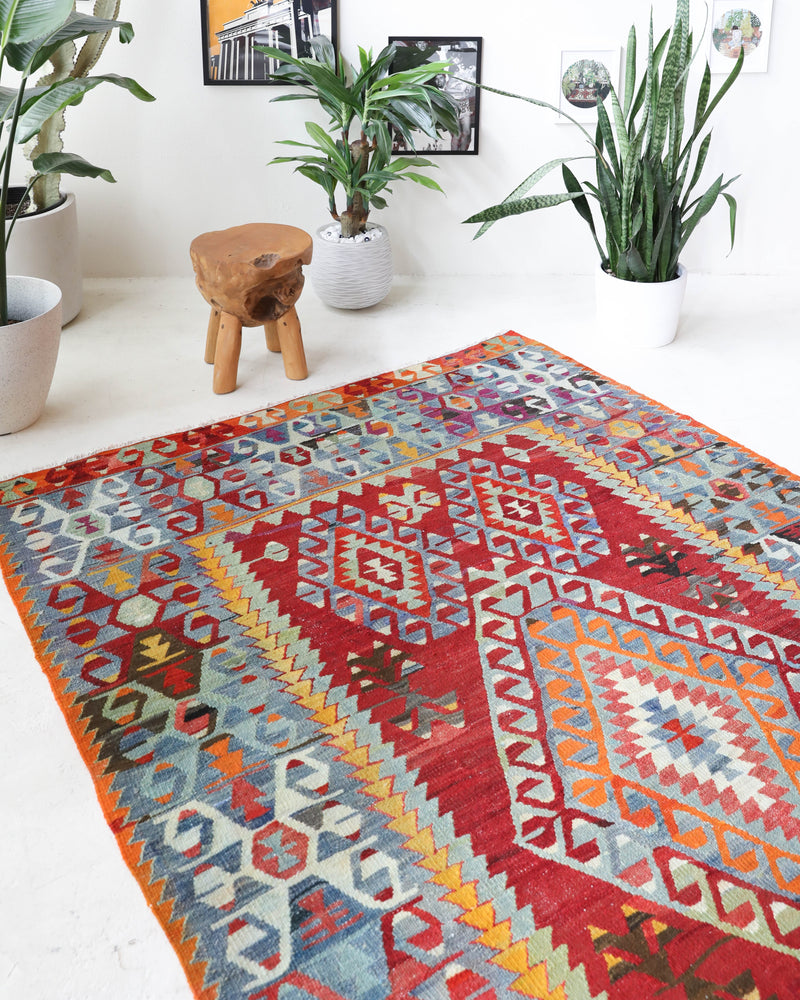 Vintage kilim rug in room decor setting, old rug, antique rug, pastel colors, faded colors, Turkish rug, vintage rug, soft rug, Portland, Oregon, rug store, rug shop, local shop, bold colors, bright colors, faded colors