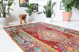 Vintage kilim rug in room decor setting, old rug, antique rug, pastel colors, faded colors, Turkish rug, vintage rug, soft rug, Portland, Oregon, rug store, rug shop, local shop, bold colors, bright colors, faded colors