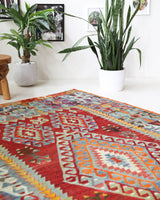 Vintage kilim rug in room decor setting, old rug, antique rug, pastel colors, faded colors, Turkish rug, vintage rug, soft rug, Portland, Oregon, rug store, rug shop, local shop, bold colors, bright colors, faded colors