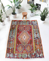 Vintage kilim rug in room decor setting, old rug, antique rug, pastel colors, faded colors, Turkish rug, vintage rug, soft rug, Portland, Oregon, rug store, rug shop, local shop, bold colors, bright colors, faded colors