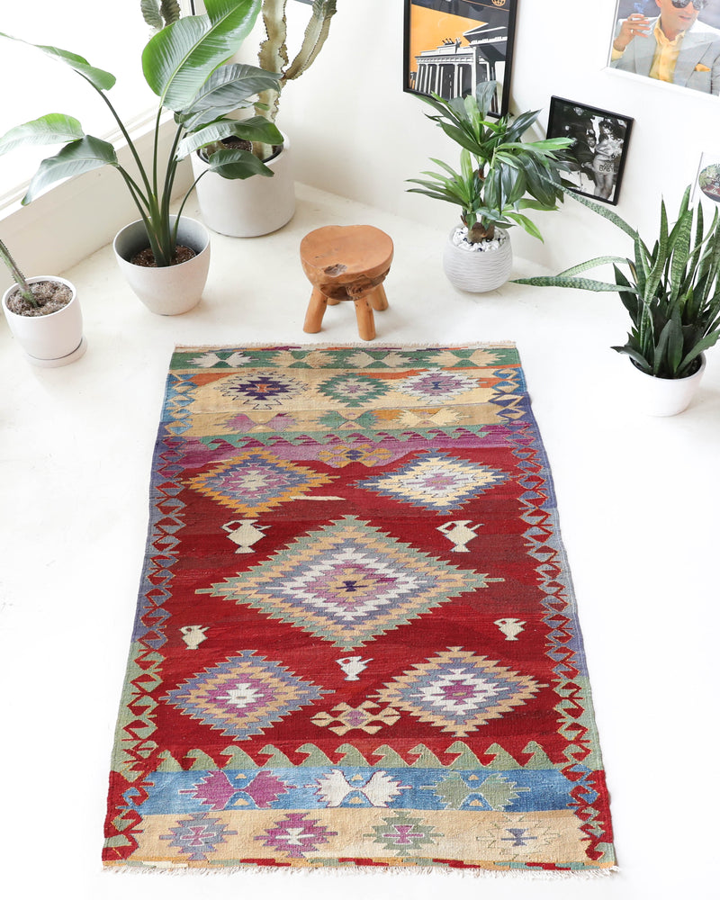 Vintage kilim rug in room decor setting, old rug, antique rug, pastel colors, faded colors, Turkish rug, vintage rug, soft rug, Portland, Oregon, rug store, rug shop, local shop, bold colors, bright colors, faded colors