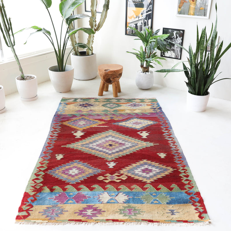 Vintage kilim rug in room decor setting, old rug, antique rug, pastel colors, faded colors, Turkish rug, vintage rug, soft rug, Portland, Oregon, rug store, rug shop, local shop, bold colors, bright colors, faded colors