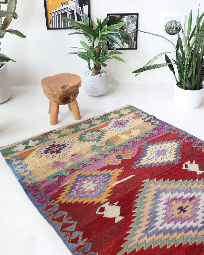 Vintage kilim rug in room decor setting, old rug, antique rug, pastel colors, faded colors, Turkish rug, vintage rug, soft rug, Portland, Oregon, rug store, rug shop, local shop, bold colors, bright colors, faded colors