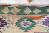 Vintage kilim rug in room decor setting, old rug, antique rug, pastel colors, faded colors, Turkish rug, vintage rug, soft rug, Portland, Oregon, rug store, rug shop, local shop, bold colors, bright colors, faded colors