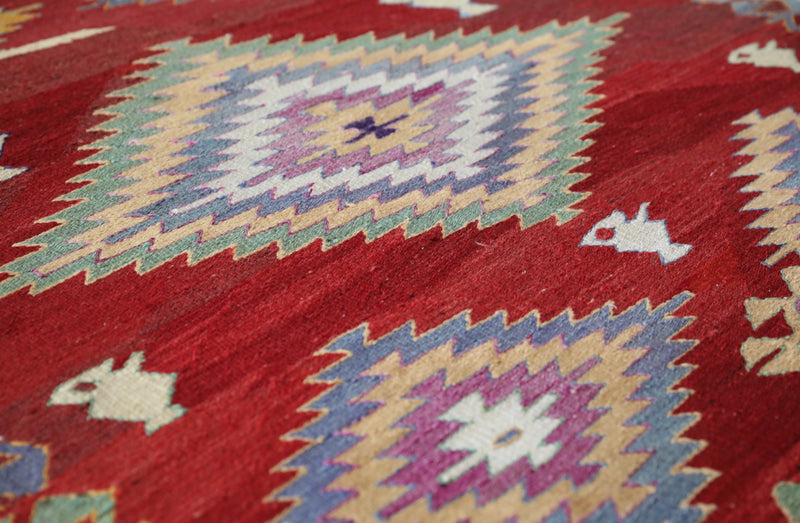 Vintage kilim rug in room decor setting, old rug, antique rug, pastel colors, faded colors, Turkish rug, vintage rug, soft rug, Portland, Oregon, rug store, rug shop, local shop, bold colors, bright colors, faded colors