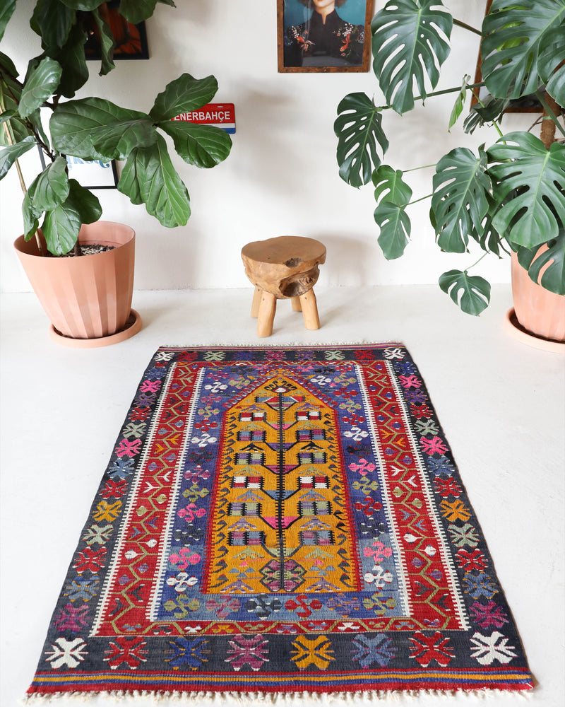 Vintage kilim rug in room decor setting, old rug, antique rug, pastel colors, faded colors, Turkish rug, vintage rug, soft rug, Portland, Oregon, rug store, rug shop, local shop, bold colors, bright colors, faded colors