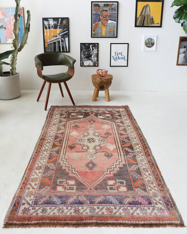 Vintage Turkish rug in living room setting, old rug, antique rug, pastel colors, faded colors, Turkish rug, vintage rug, soft rug, Portland, Oregon, rug store, rug shop, local shop