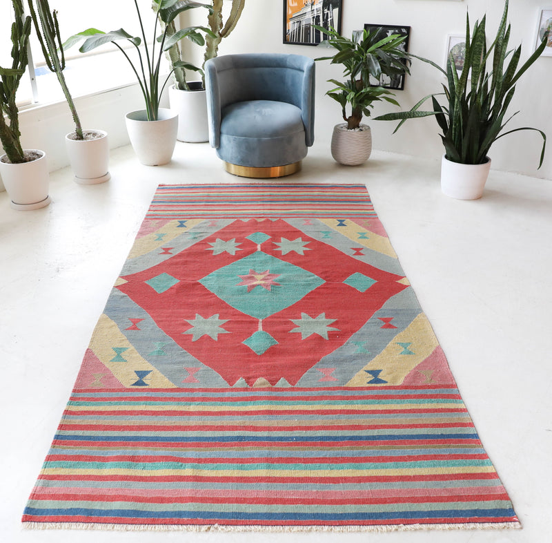 Vintage kilim rug in room decor setting, old rug, antique rug, pastel colors, faded colors, Turkish rug, vintage rug, soft rug, Portland, Oregon, rug store, rug shop, local shop, bold colors, bright colors, faded colors