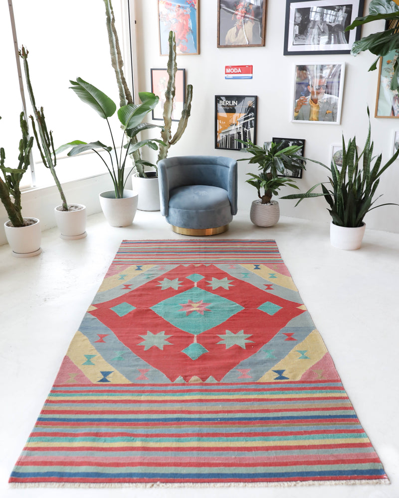 Vintage kilim rug in room decor setting, old rug, antique rug, pastel colors, faded colors, Turkish rug, vintage rug, soft rug, Portland, Oregon, rug store, rug shop, local shop, bold colors, bright colors, faded colors