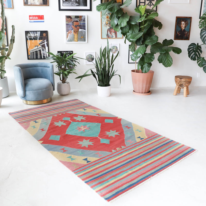 Vintage kilim rug in room decor setting, old rug, antique rug, pastel colors, faded colors, Turkish rug, vintage rug, soft rug, Portland, Oregon, rug store, rug shop, local shop, bold colors, bright colors, faded colors