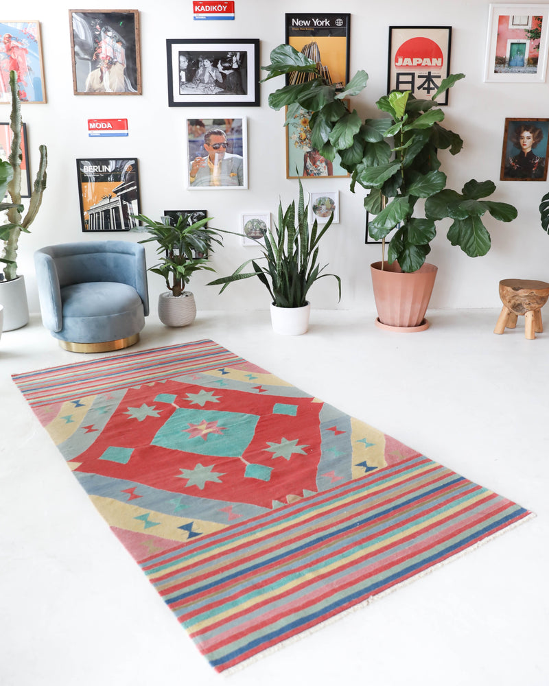 Vintage kilim rug in room decor setting, old rug, antique rug, pastel colors, faded colors, Turkish rug, vintage rug, soft rug, Portland, Oregon, rug store, rug shop, local shop, bold colors, bright colors, faded colors