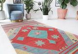 Vintage kilim rug in room decor setting, old rug, antique rug, pastel colors, faded colors, Turkish rug, vintage rug, soft rug, Portland, Oregon, rug store, rug shop, local shop, bold colors, bright colors, faded colors