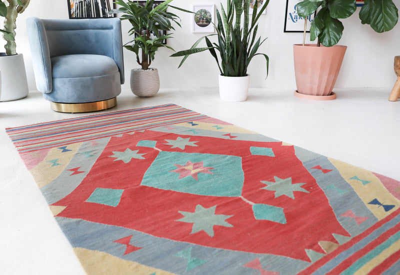 Vintage kilim rug in room decor setting, old rug, antique rug, pastel colors, faded colors, Turkish rug, vintage rug, soft rug, Portland, Oregon, rug store, rug shop, local shop, bold colors, bright colors, faded colors