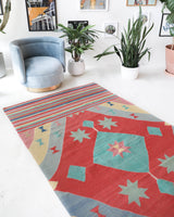 Vintage kilim rug in room decor setting, old rug, antique rug, pastel colors, faded colors, Turkish rug, vintage rug, soft rug, Portland, Oregon, rug store, rug shop, local shop, bold colors, bright colors, faded colors