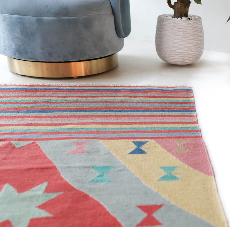 Vintage kilim rug in room decor setting, old rug, antique rug, pastel colors, faded colors, Turkish rug, vintage rug, soft rug, Portland, Oregon, rug store, rug shop, local shop, bold colors, bright colors, faded colors