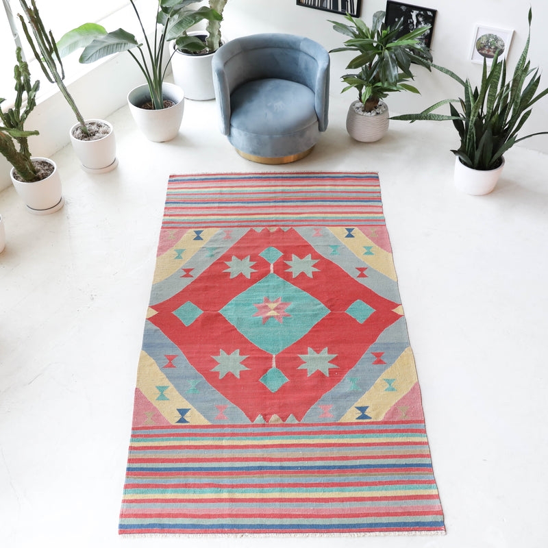 Vintage kilim rug in room decor setting, old rug, antique rug, pastel colors, faded colors, Turkish rug, vintage rug, soft rug, Portland, Oregon, rug store, rug shop, local shop, bold colors, bright colors, faded colors