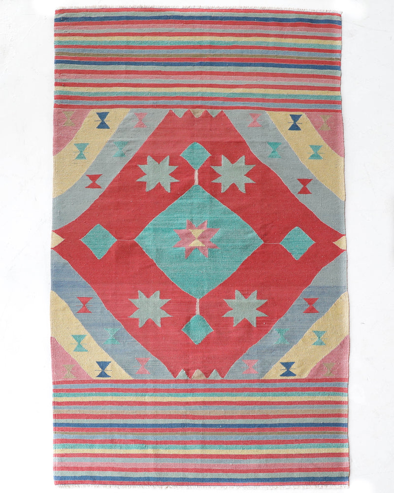 Vintage kilim rug in room decor setting, old rug, antique rug, pastel colors, faded colors, Turkish rug, vintage rug, soft rug, Portland, Oregon, rug store, rug shop, local shop, bold colors, bright colors, faded colors