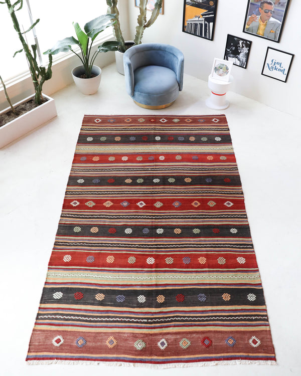 Vintage kilim rug in living room setting, old rug, antique rug, pastel colors, faded colors, Turkish rug, vintage rug, soft rug, Portland, Oregon, rug store, rug shop, local shop, earthy tones, earthy colors, warm colors