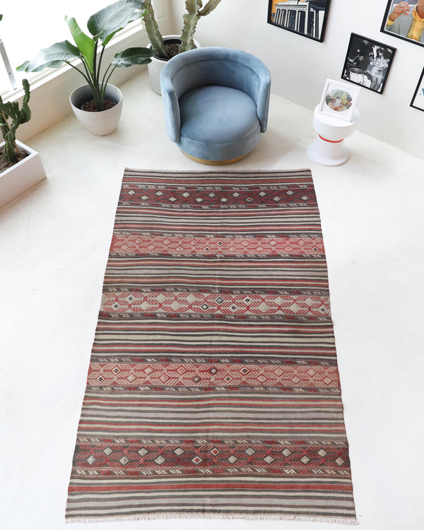 Vintage kilim rug in room decor setting, old rug, antique rug, pastel colors, faded colors, Turkish rug, vintage rug, soft rug, Portland, Oregon, rug store, rug shop, local shop, bold colors, bright colors, faded colors