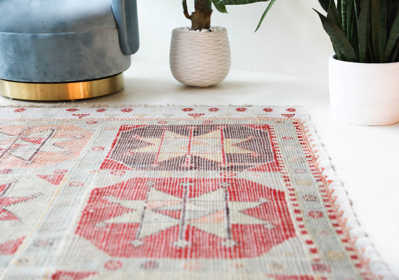 Vintage kilim rug in living room setting, old rug, antique rug, pastel colors, faded colors, Turkish rug, vintage rug, soft rug, Portland, Oregon, rug store, rug shop, local shop, earthy tones, earthy colors, warm colors