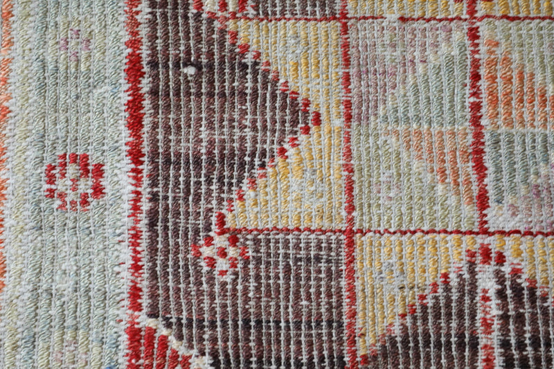 Vintage kilim rug in living room setting, old rug, antique rug, pastel colors, faded colors, Turkish rug, vintage rug, soft rug, Portland, Oregon, rug store, rug shop, local shop, earthy tones, earthy colors, warm colors