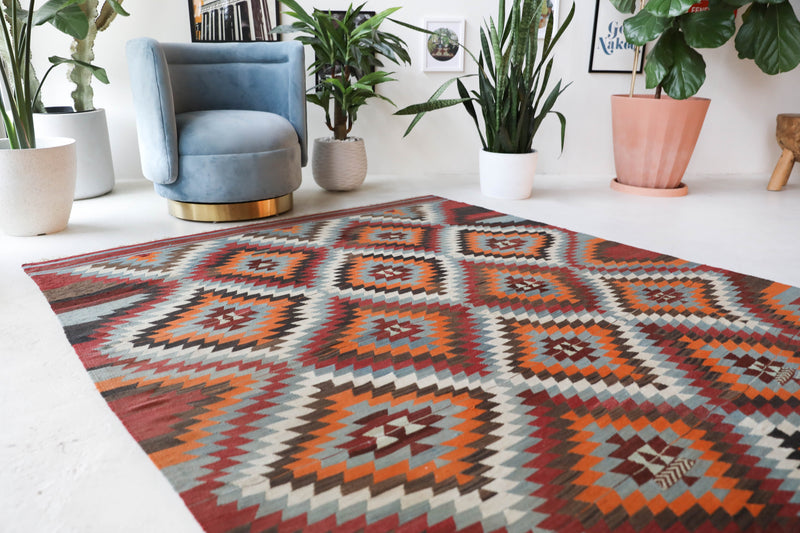 Vintage kilim rug in room decor setting, old rug, antique rug, pastel colors, faded colors, Turkish rug, vintage rug, soft rug, Portland, Oregon, rug store, rug shop, local shop, bold colors, bright colors, faded colors