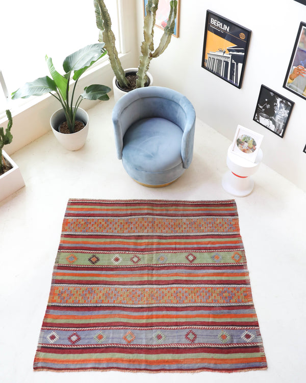 Vintage kilim rug in room decor setting, old rug, antique rug, pastel colors, faded colors, Turkish rug, vintage rug, soft rug, Portland, Oregon, rug store, rug shop, local shop, bold colors, bright colors, faded colors