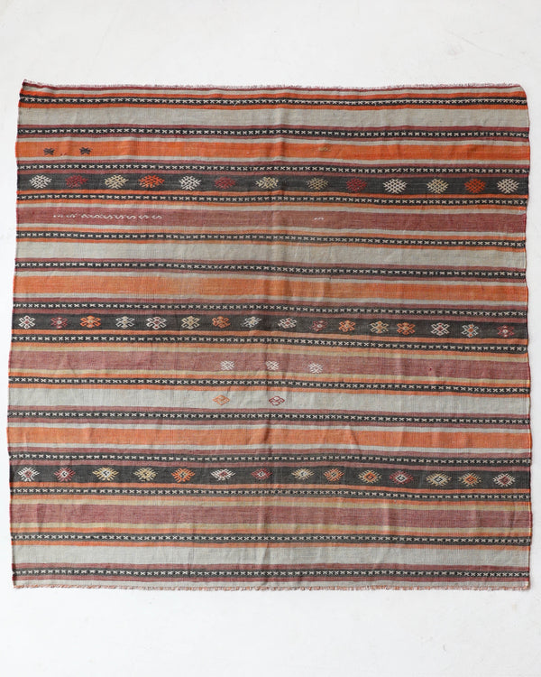 Vintage kilim rug in living room setting, old rug, antique rug, pastel colors, faded colors, Turkish rug, vintage rug, soft rug, Portland, Oregon, rug store, rug shop, local shop, earthy tones, earthy colors, warm colors