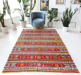 Vintage kilim rug in room decor setting, old rug, antique rug, pastel colors, faded colors, Turkish rug, vintage rug, soft rug, Portland, Oregon, rug store, rug shop, local shop, bold colors, bright colors, faded colors