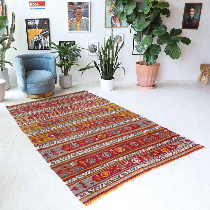 Vintage kilim rug in room decor setting, old rug, antique rug, pastel colors, faded colors, Turkish rug, vintage rug, soft rug, Portland, Oregon, rug store, rug shop, local shop, bold colors, bright colors, faded colors