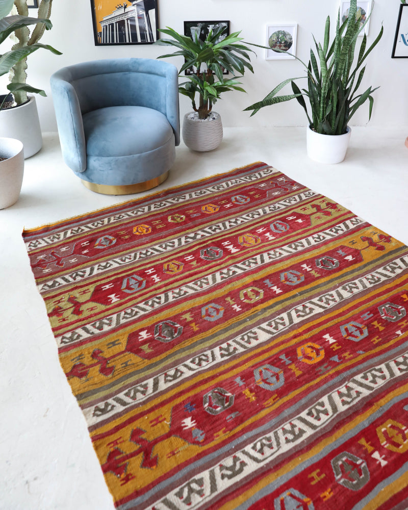 Vintage kilim rug in room decor setting, old rug, antique rug, pastel colors, faded colors, Turkish rug, vintage rug, soft rug, Portland, Oregon, rug store, rug shop, local shop, bold colors, bright colors, faded colors