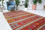 Vintage kilim rug in room decor setting, old rug, antique rug, pastel colors, faded colors, Turkish rug, vintage rug, soft rug, Portland, Oregon, rug store, rug shop, local shop, bold colors, bright colors, faded colors