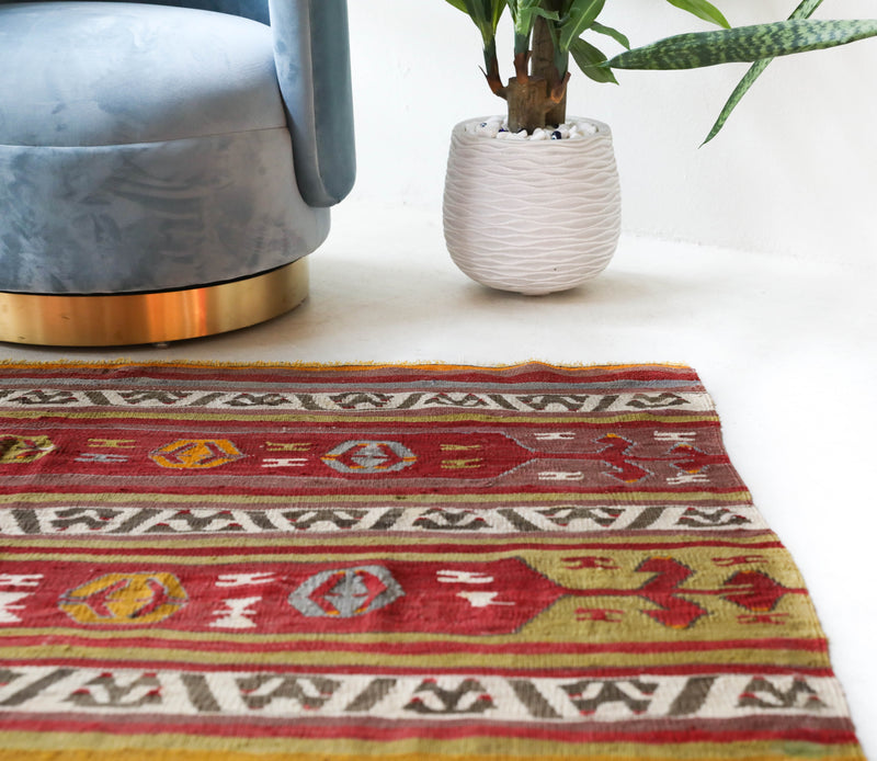 Vintage kilim rug in room decor setting, old rug, antique rug, pastel colors, faded colors, Turkish rug, vintage rug, soft rug, Portland, Oregon, rug store, rug shop, local shop, bold colors, bright colors, faded colors