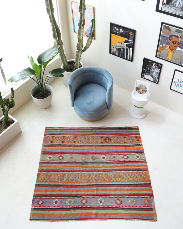 Vintage kilim rug in living room setting, old rug, antique rug, pastel colors, faded colors, Turkish rug, vintage rug, soft rug, Portland, Oregon, rug store, rug shop, local shop, earthy tones, earthy colors, warm colors