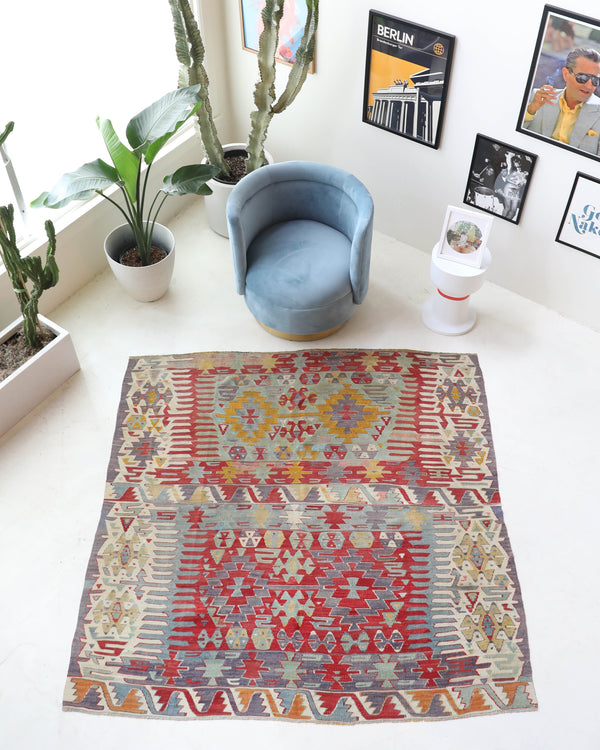 Vintage kilim rug in room decor setting, old rug, antique rug, pastel colors, faded colors, Turkish rug, vintage rug, soft rug, Portland, Oregon, rug store, rug shop, local shop, bold colors, bright colors, faded colors