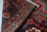 Antique Persian area rug in a living room setting, pile rug, vintage rug, portland, rug shop, bright colors, wild shaman, soft rug, bold color, Portland, Oregon, rug store, rug shop, local shop, antique rug, Persian rug, handmade rug, wool rug, distressed rug