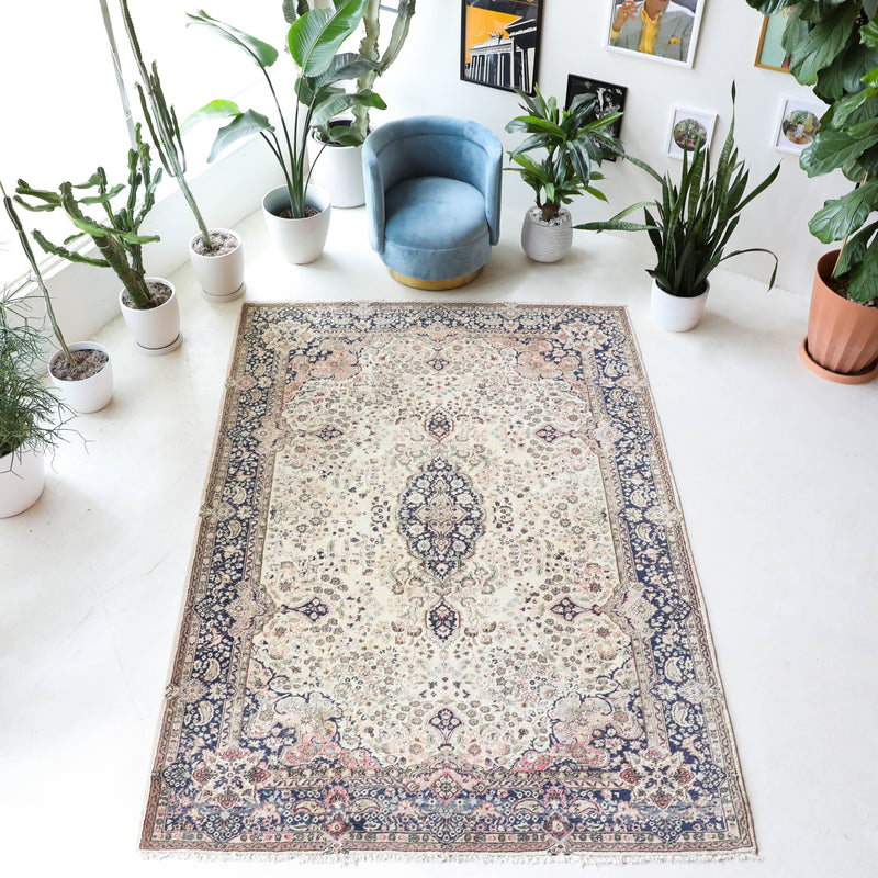 Vintage Turkish rug in a living room setting, Area rug in a living room setting, pile rug, Turkish rug, old rug, antique rug, pastel colors, faded colors, Turkish rug, vintage rug, soft rug, Portland, Oregon, rug store, rug shop, local shop, distressed rug, worn out rug