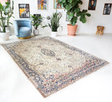 Vintage Turkish rug in a living room setting, Area rug in a living room setting, pile rug, Turkish rug, old rug, antique rug, pastel colors, faded colors, Turkish rug, vintage rug, soft rug, Portland, Oregon, rug store, rug shop, local shop, distressed rug, worn out rug