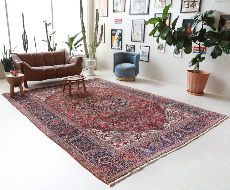 Antique Persian area rug in a living room setting, pile rug, vintage rug, portland, rug shop, bright colors, wild shaman, soft rug, bold color, Portland, Oregon, rug store, rug shop, local shop, antique rug, Persian rug, handmade rug, wool rug, distressed rug