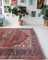 Antique Persian area rug in a living room setting, pile rug, vintage rug, portland, rug shop, bright colors, wild shaman, soft rug, bold color, Portland, Oregon, rug store, rug shop, local shop, antique rug, Persian rug, handmade rug, wool rug, distressed rug