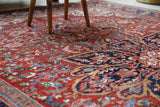 Antique Persian area rug in a living room setting, pile rug, vintage rug, portland, rug shop, bright colors, wild shaman, soft rug, bold color, Portland, Oregon, rug store, rug shop, local shop, antique rug, Persian rug, handmade rug, wool rug, distressed rug